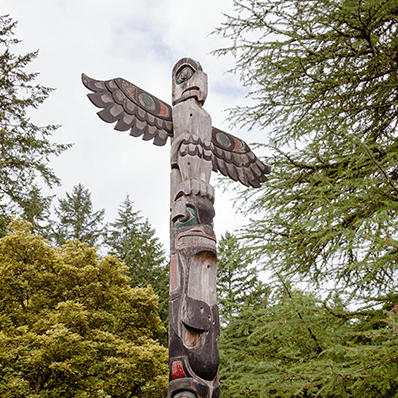 a totem pole in the wilderness