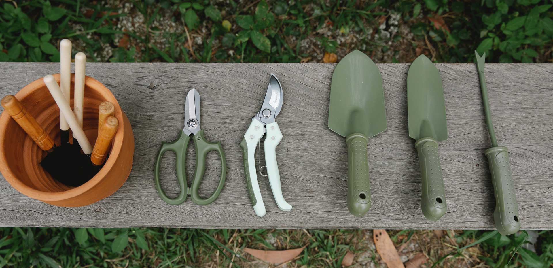 garden tools sitting on a wooden bench