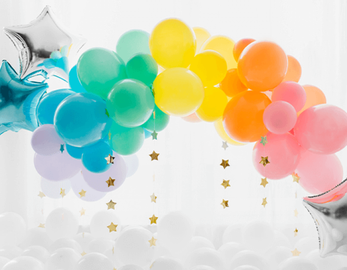 a balloon arch with rainbow balloons