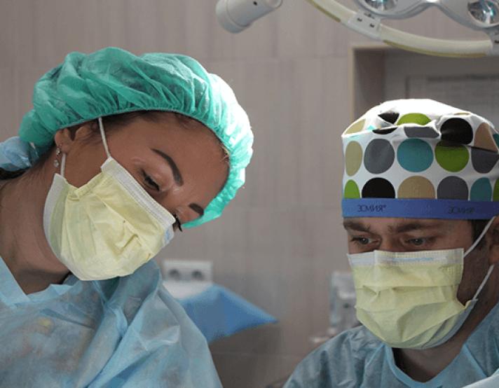 two healthcare workers look at a patient