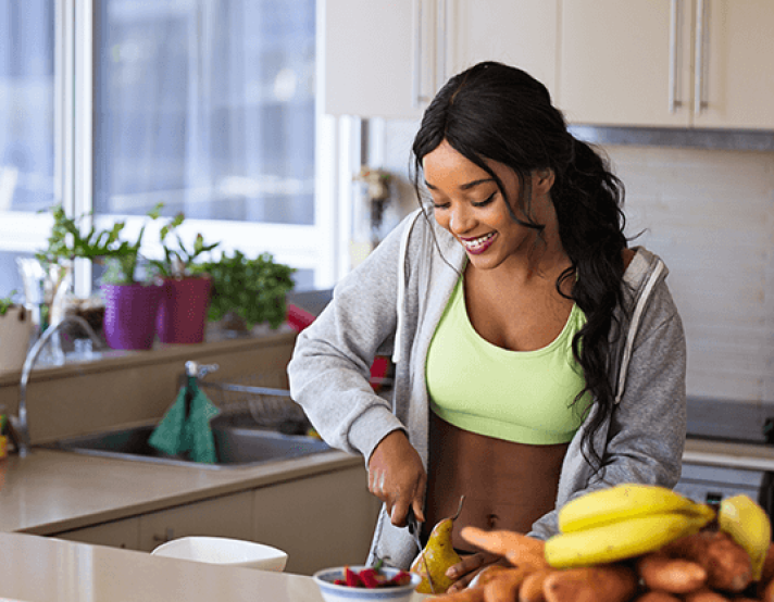 a woman cuts healthy food