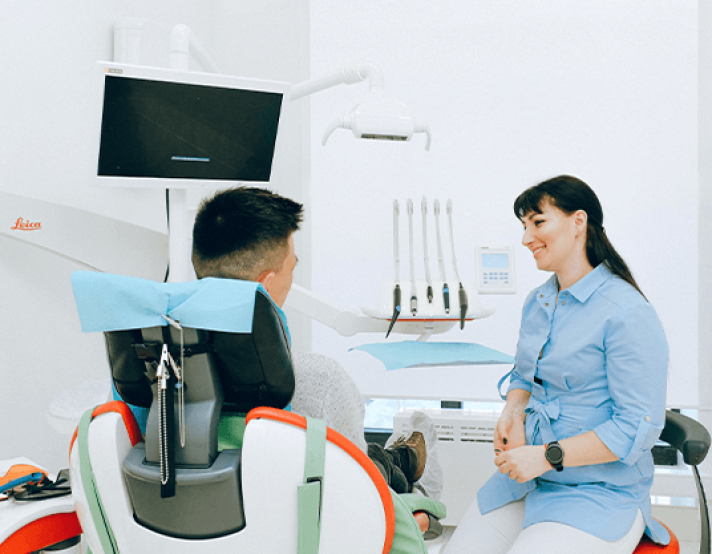 two people talk in a dentist office