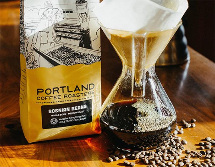 portland coffee roasters bag of coffee next to a fresh brewed pour-over pot of coffee